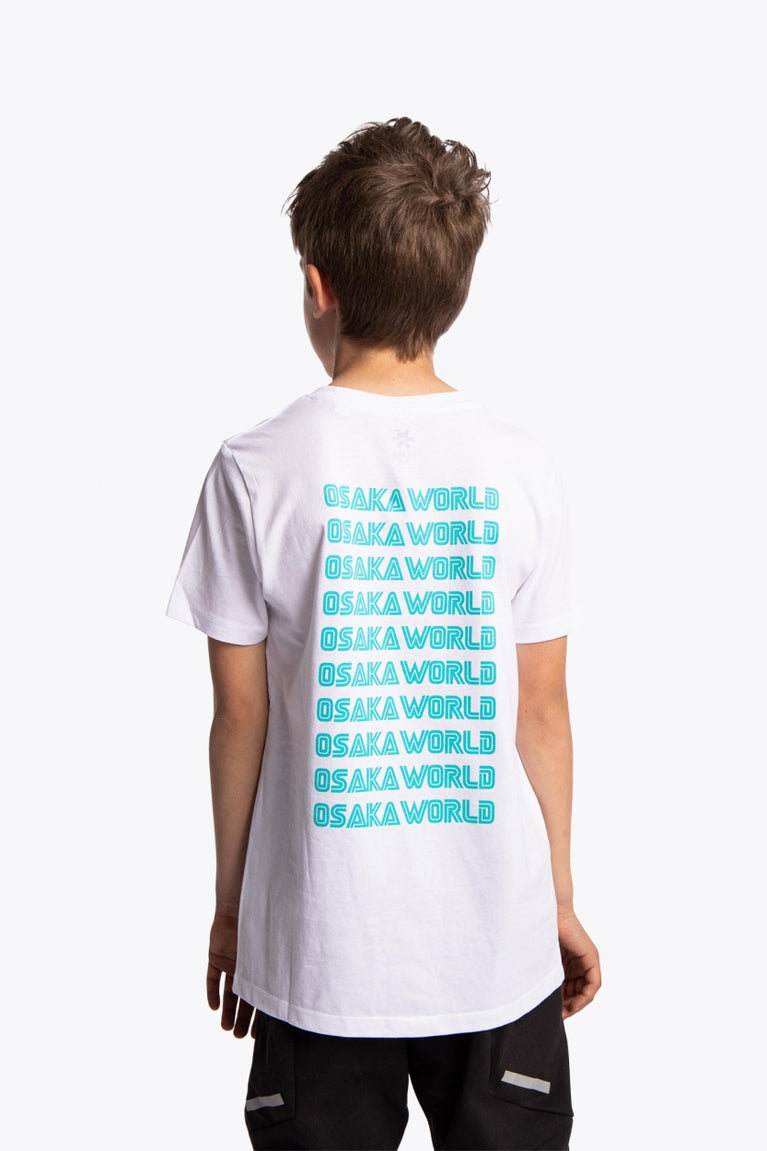 Boy wearing the Osaka kids service games tee short sleeve white with logo in blue. Back view