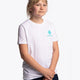 Girl wearing the Osaka kids service games tee short sleeve white with logo in blue. Front view