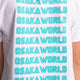 Osaka kids service games tee short sleeve white with logo in blue. Detail view logo back