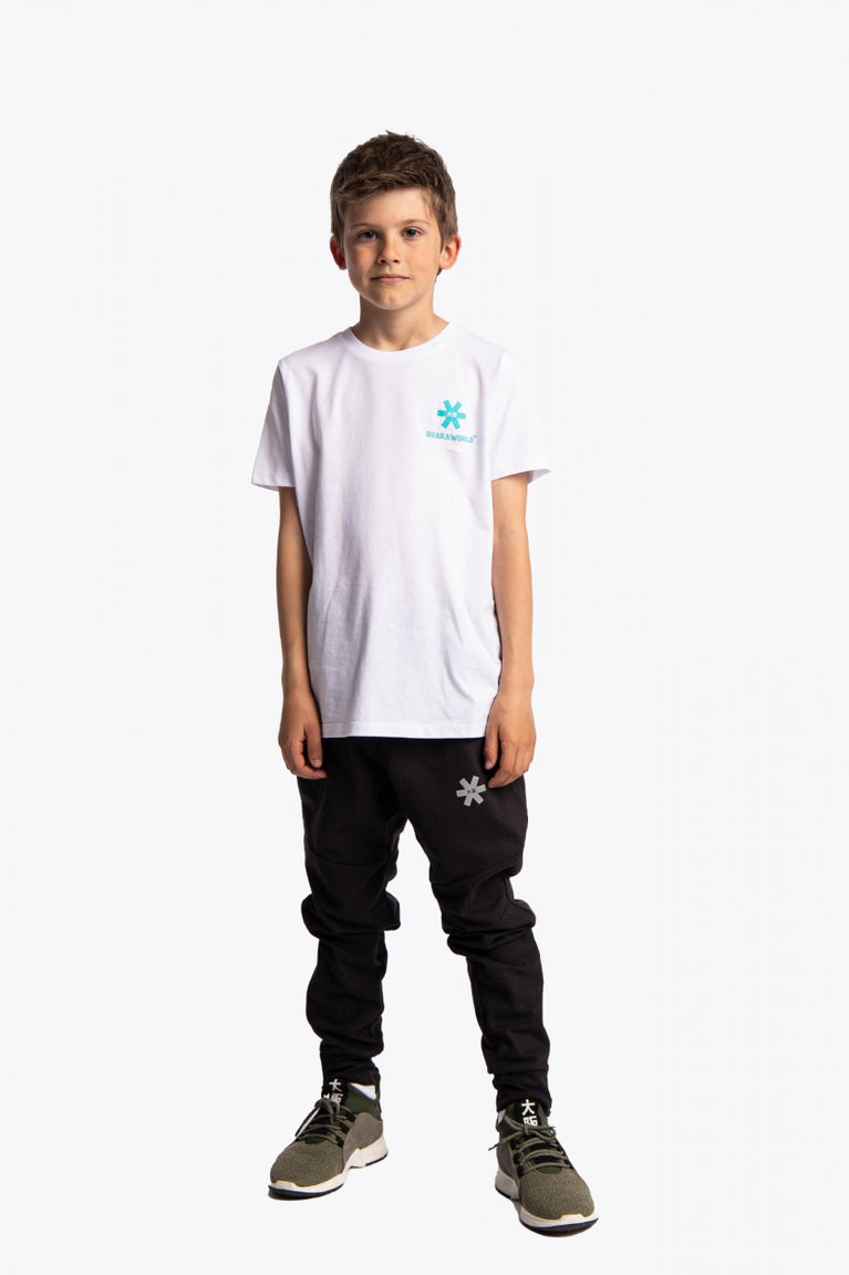 Boy wearing the Osaka kids service games tee short sleeve white with logo in blue. Front fullview