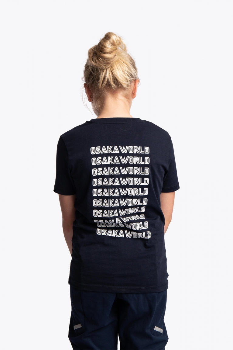 Girl wearing the Osaka kids service games tee short sleeve navy with logo in white. Back view