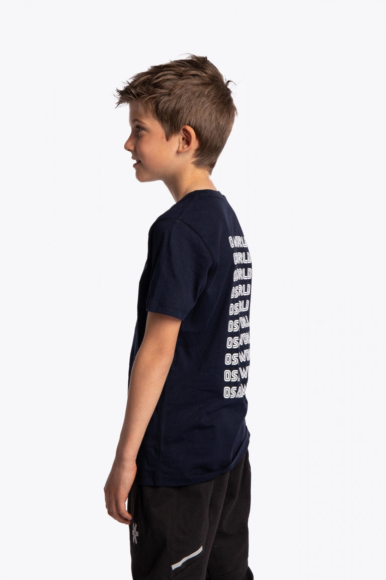 Boy wearing the Osaka kids service games tee short sleeve navy with logo in white. Side view