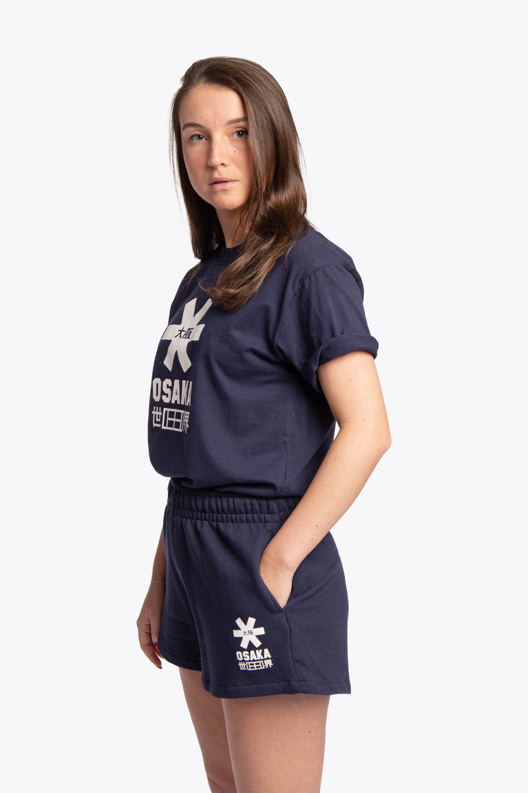 Woman wearing the Osaka women shorts in navy with white logo. Side view