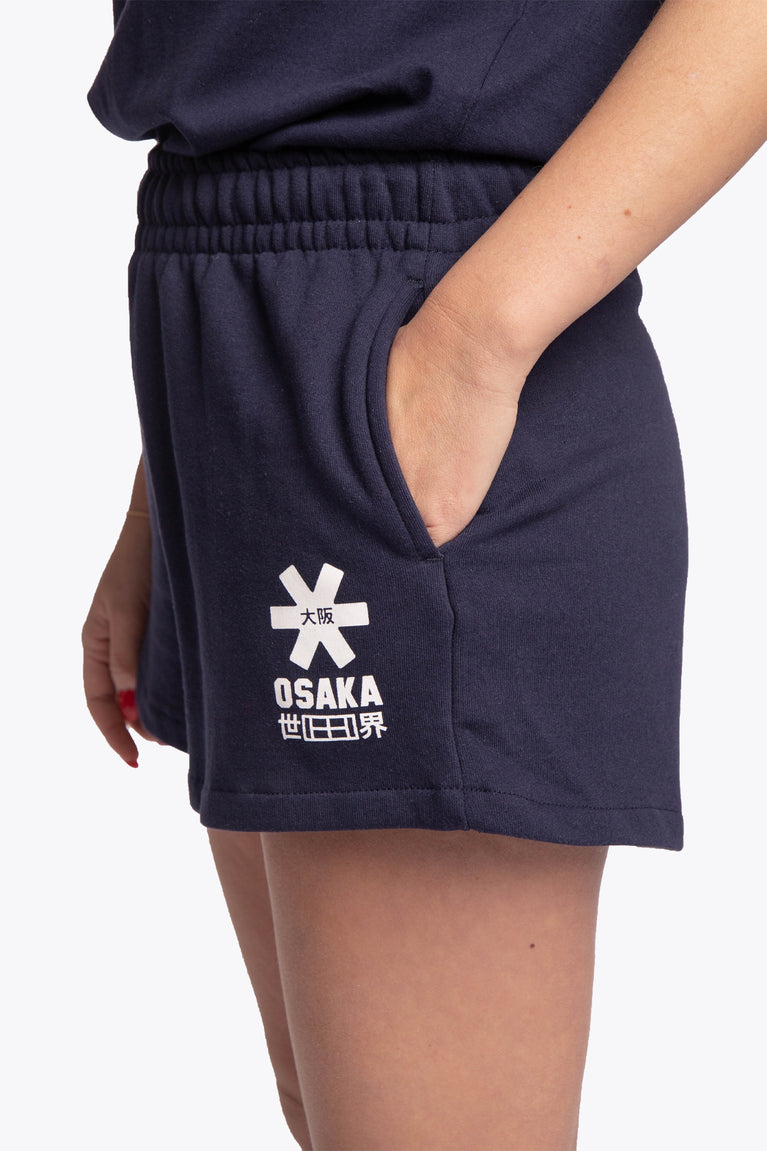 Woman wearing the Osaka women shorts in navy with white logo. Side detail logo view