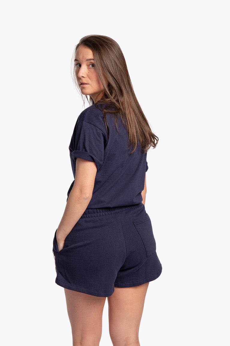 Woman wearing the Osaka women shorts in navy with white logo. Back view