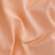 Osaka women ball skort in peach with logo in grey. Detail fabric view