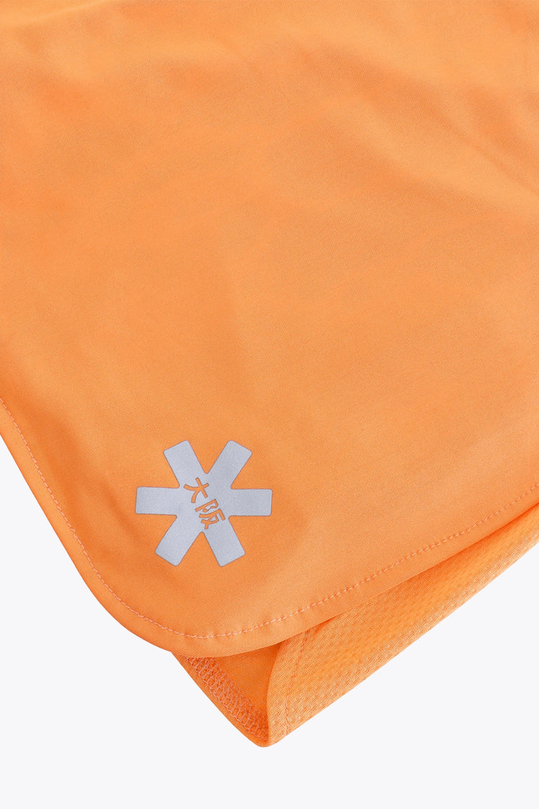 Osaka women ball skort in orange with logo in white. Detail logo view