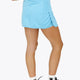 Woman wearing the Osaka women ball skort in light blue with logo in grey. Back view