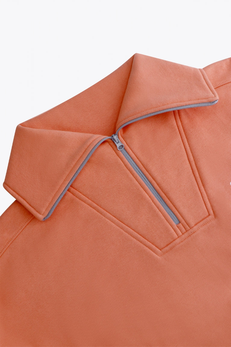 Osaka women half zip sweater in peach with white logo. Front flatlay detail neck view