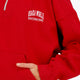 Osaka women half zip sweater in red with white logo. Front detail sleeve view