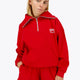 Woman wearing the Osaka women half zip sweater in red with white logo. Front view