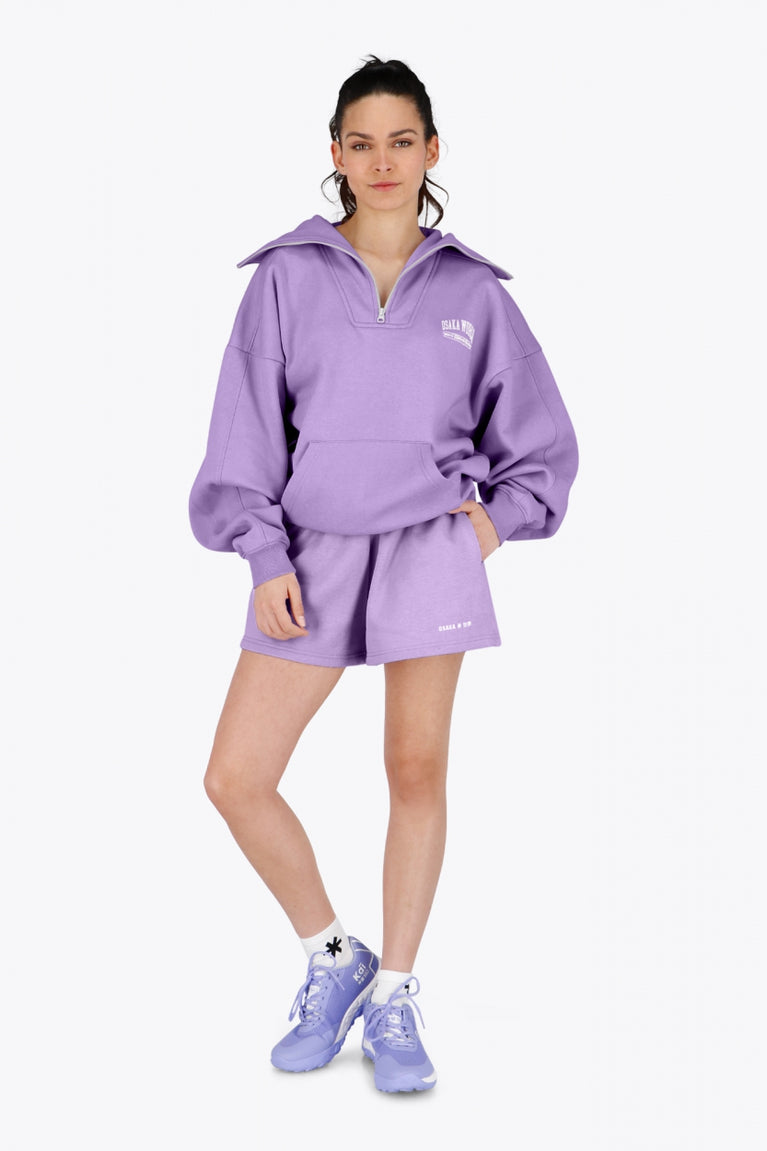 Osaka women half zip sweater in light purple with white logo. Front view