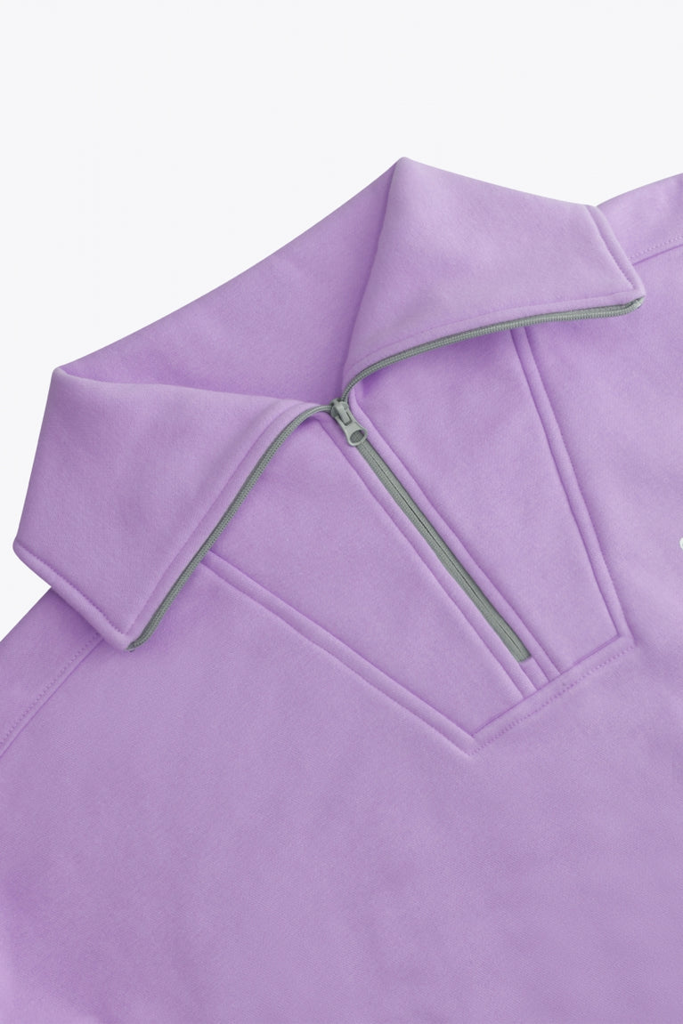 Osaka women half zip sweater in light purple with white logo. Front detail neck view