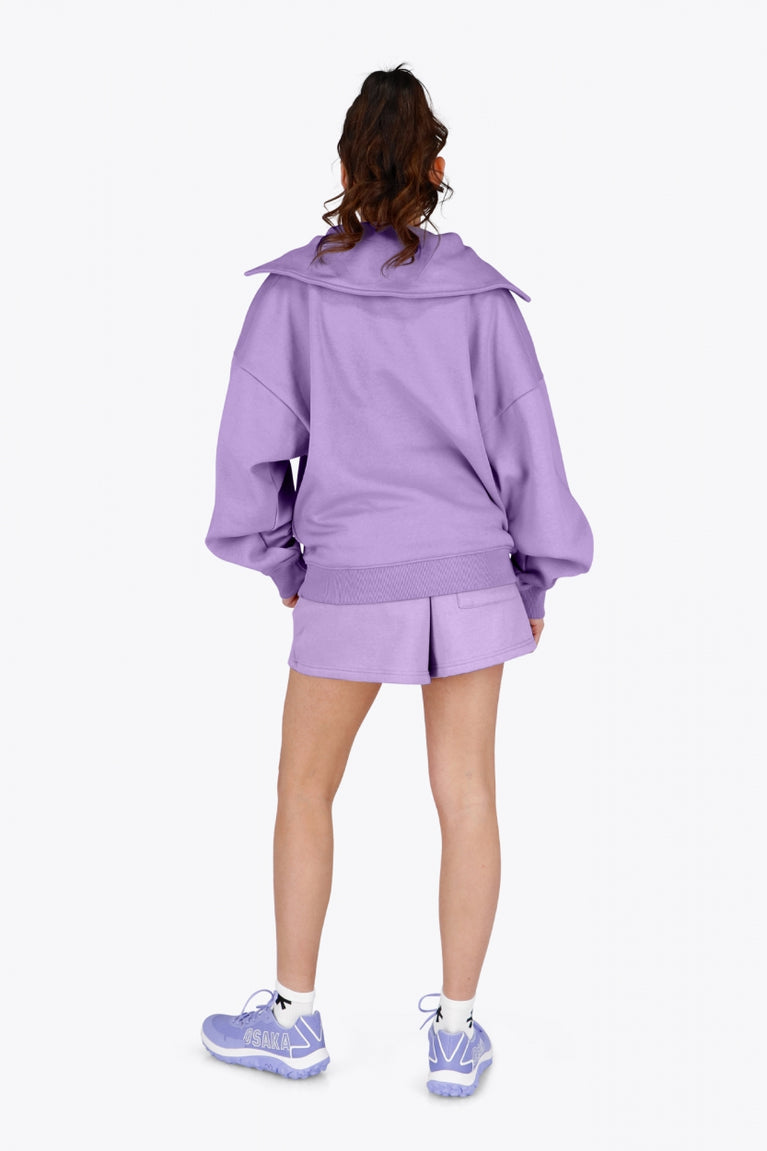 Osaka women half zip sweater in light purple with white logo. Back view