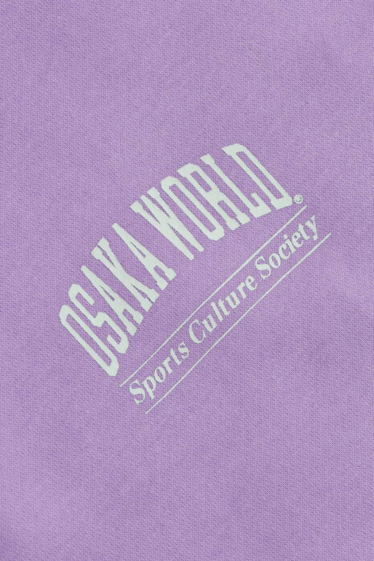 Osaka women half zip sweater in light purple with white logo. Detail logo view