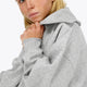 Osaka women half zip sweater in heather grey with white logo. Side detail sleeve view