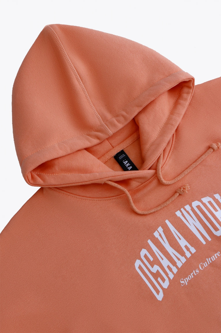 Osaka women hoodie in peach with white logo. Front flatlay logo view