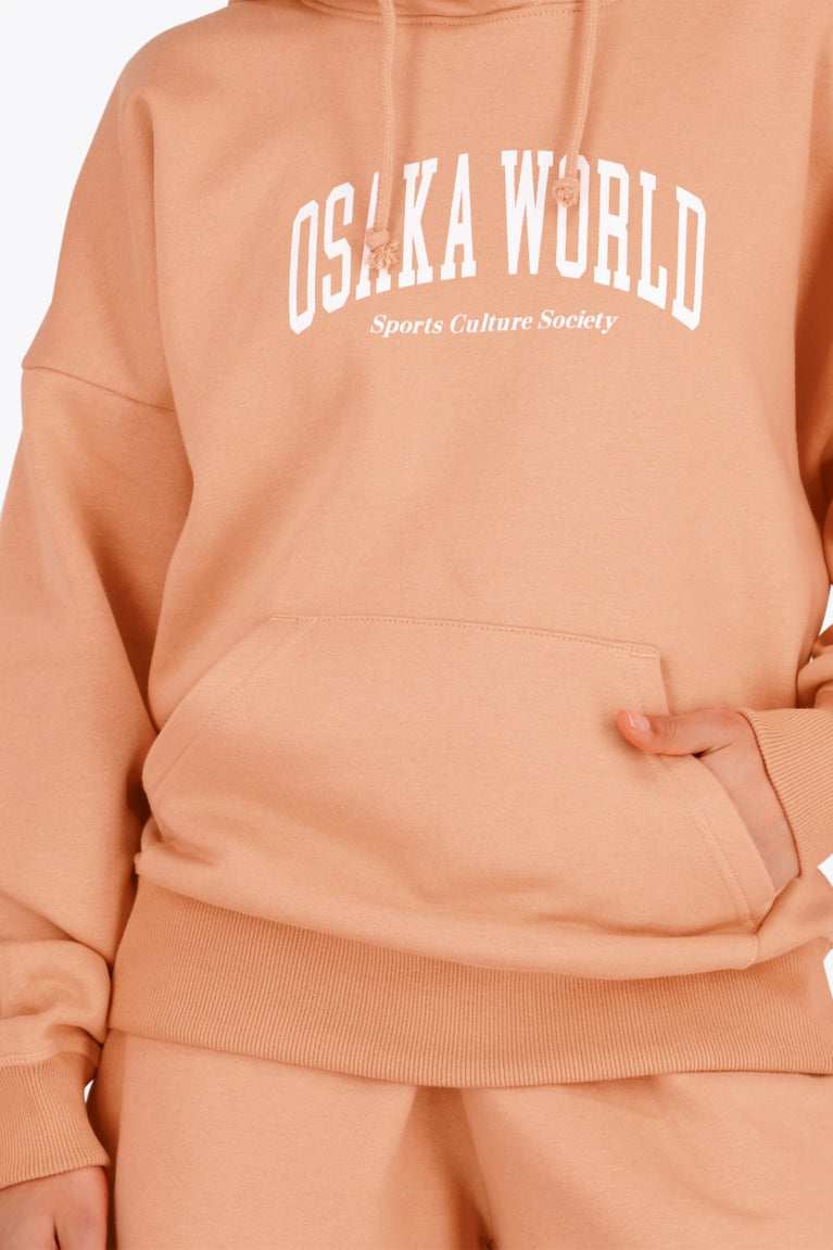 Osaka women hoodie in peach with white logo. Front view