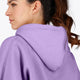 Woman wearing the Osaka women hoodie in light purple with white logo. Back detail cap view