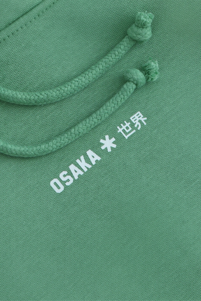 Osaka women hoodie in green with white logo. Detail front logo view