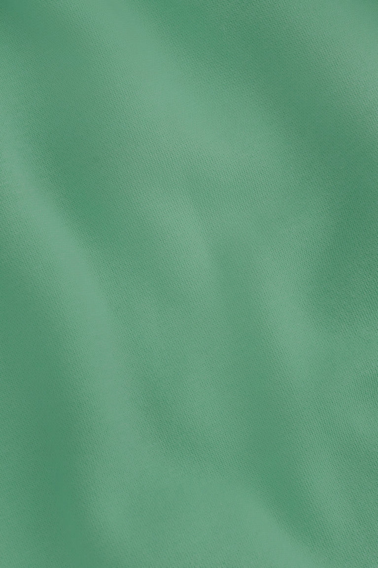 Osaka women hoodie in green with white logo. Detail fabric view
