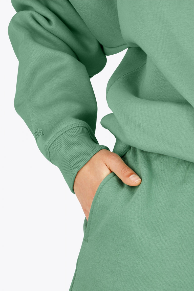 Osaka women hoodie in green with white logo. Detail sleeve view