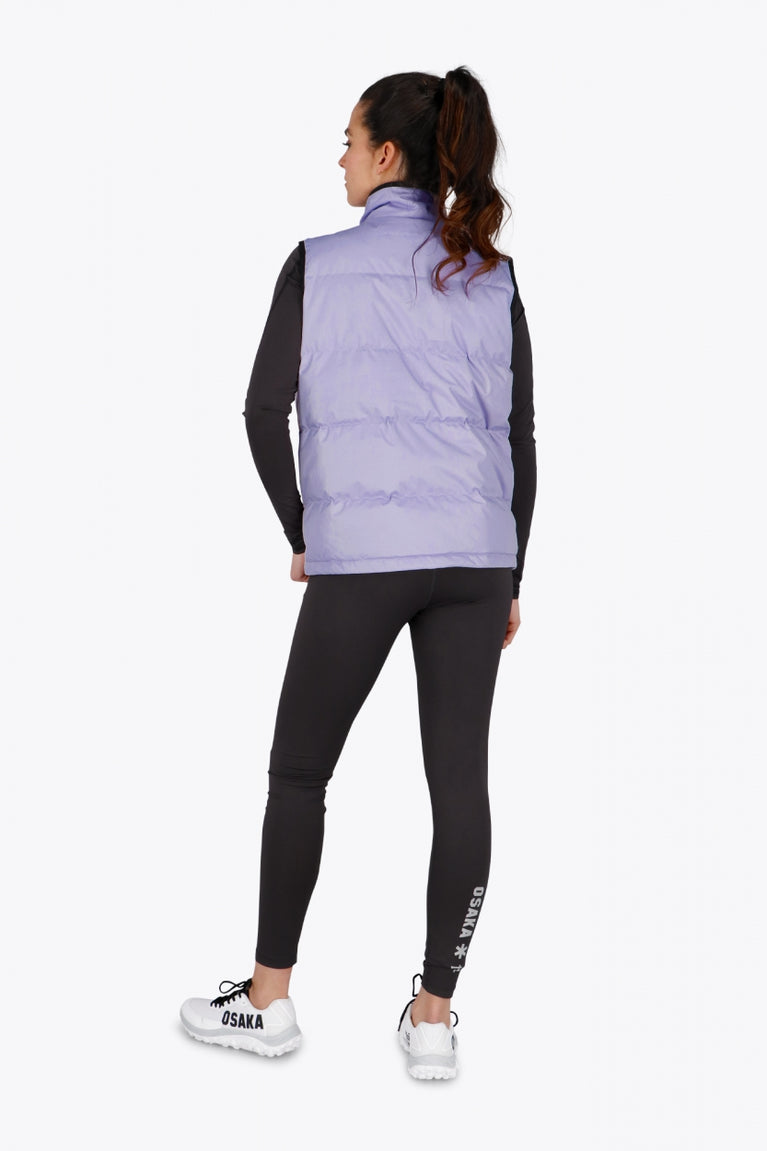 Woman wearing the Osaka women padded gilet in purple with grey logo. Back view