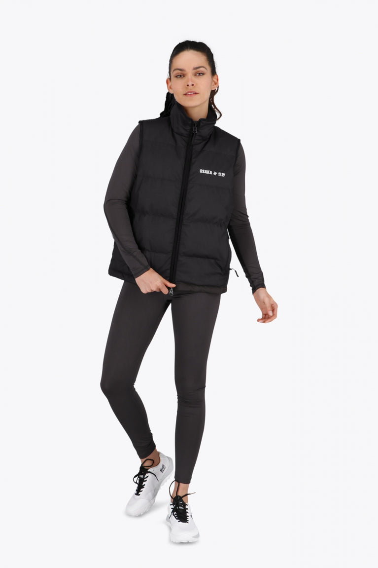 Woman wearing the Osaka women padded gilet in black with white logo. Front view
