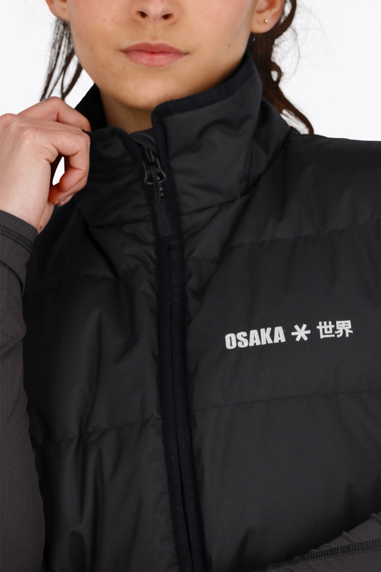Osaka women padded gilet in black with white logo. Front detail logo view