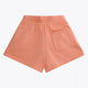 Osaka women shorts in peach with logo in white. Back flatlay view