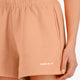Osaka women shorts in peach with logo in white. Front detail logo view