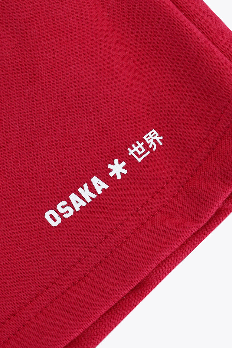 Osaka women shorts in red with logo in white. Front flatlay detail logo view