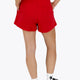Woman wearing the Osaka women shorts in red with logo in white. Back view