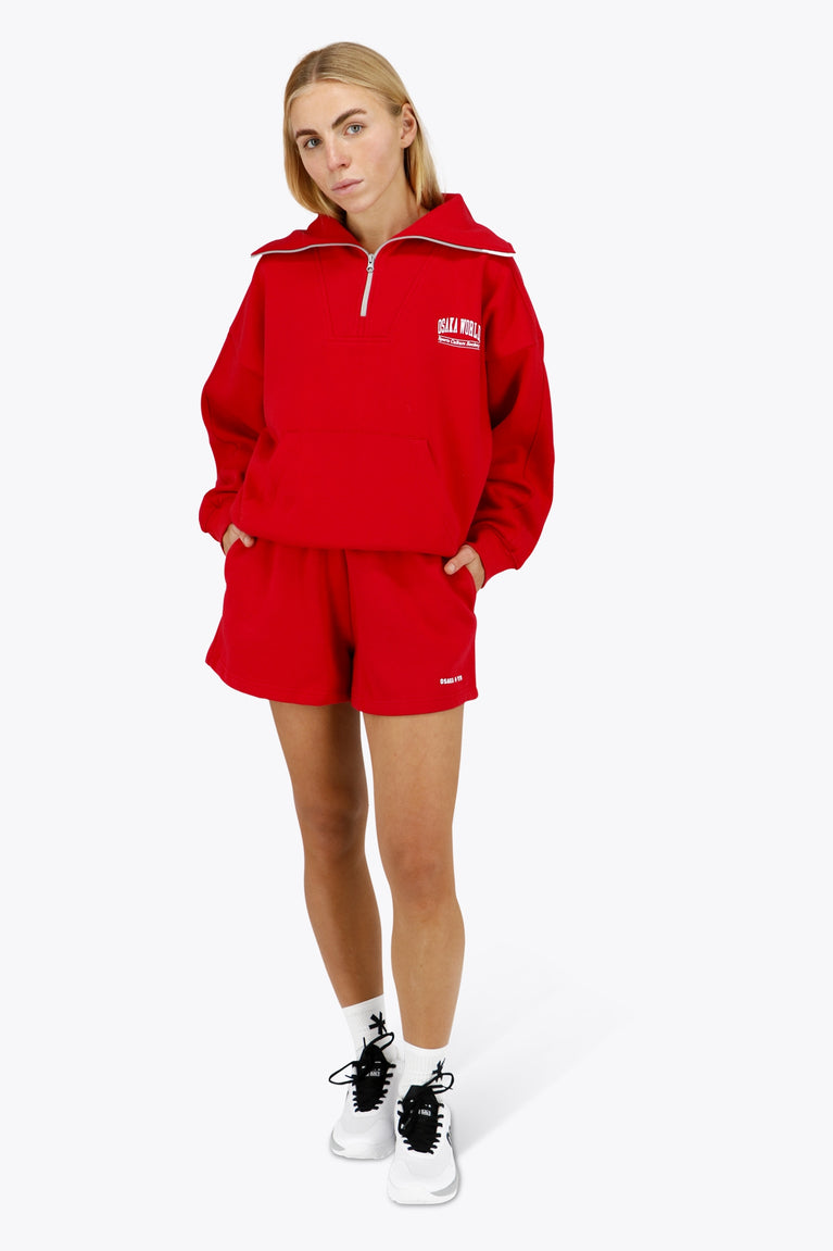 Woman wearing the Osaka women shorts in red with logo in white. Front view