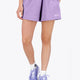Woman wearing the Osaka women shorts in light purple with logo in white. Front view