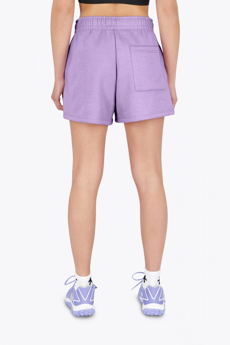 Woman wearing the Osaka women shorts in light purple with logo in white. Back view