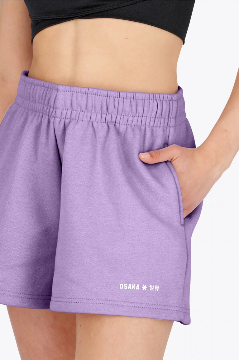 Osaka women shorts in light purple with logo in white. Front detail logo view