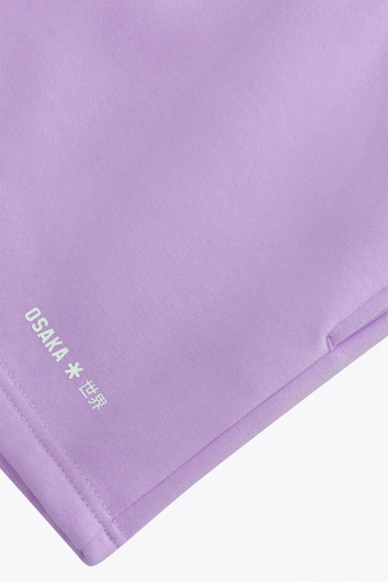 Osaka women shorts in light purple with logo in white. Front flatlay detail logo view