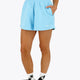 Woman wearing the Osaka women shorts in light blue with logo in white. Front view