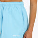Woman wearing the Osaka women shorts in light blue with logo in white. Front detail logo view
