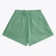Osaka women shorts in green with logo in white. Front flatlay view