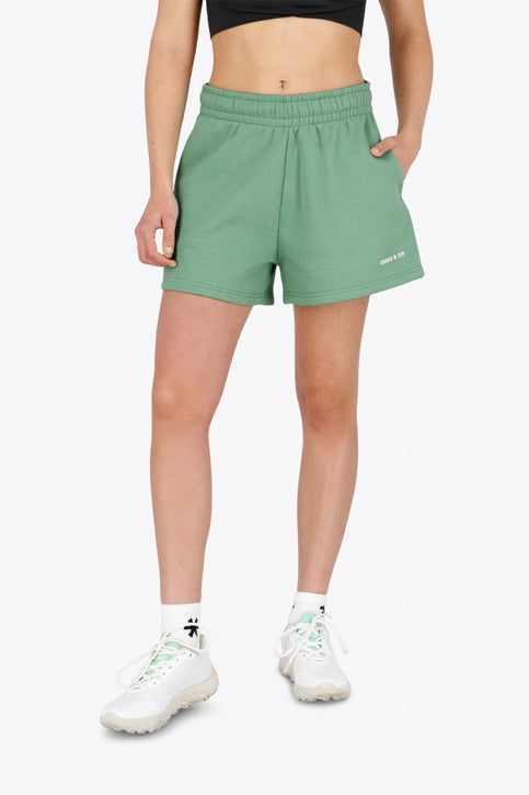 Osaka women shorts in green with logo in white. Front flatlay view