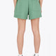 Woman wearing the Osaka women shorts in green with logo in white. Back view