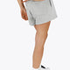 Woman wearing the Osaka women shorts in heather grey with logo in white. Back view