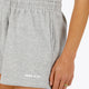 Woman wearing the Osaka women shorts in heather grey with logo in white. Front view