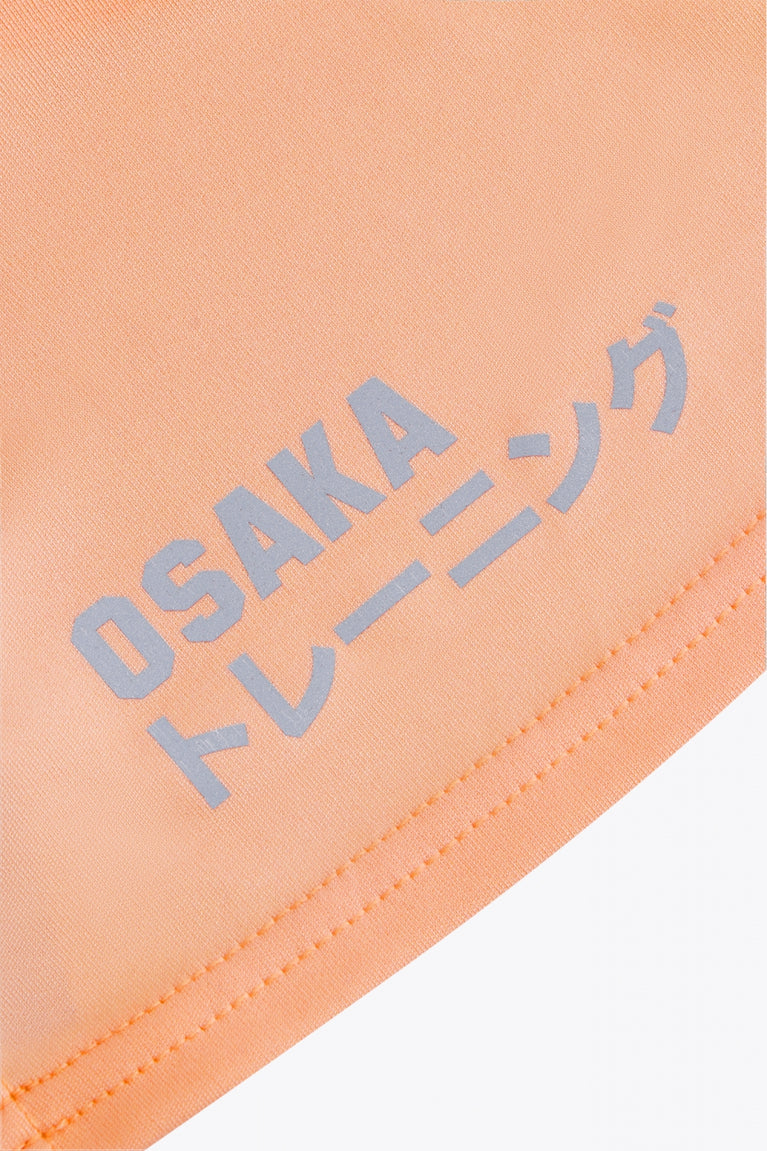Osaka women singlet in peach with logo in grey. Back flatlay logo view