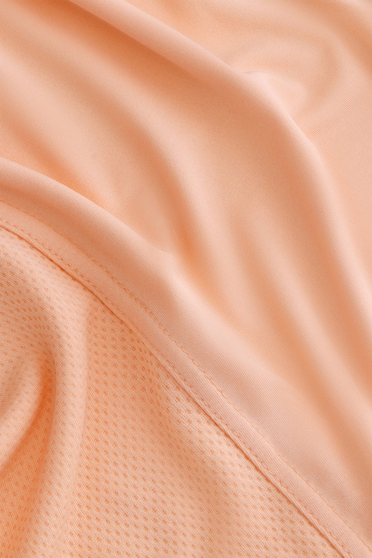 Osaka women singlet in peach with logo in grey. Detail fabric view