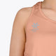 Woman wearing the Osaka women singlet in peach with logo in grey. Front logo view