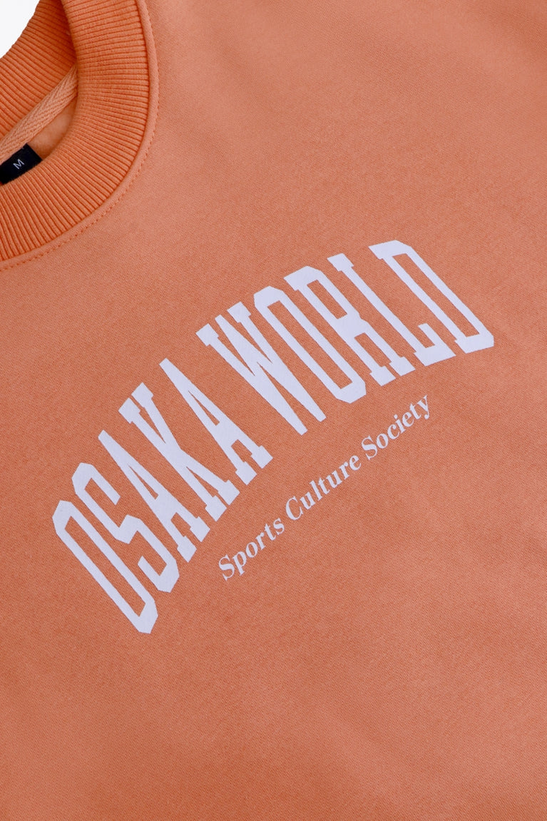 Osaka women sweater in peach with logo in white. Front flatlay detail logo view