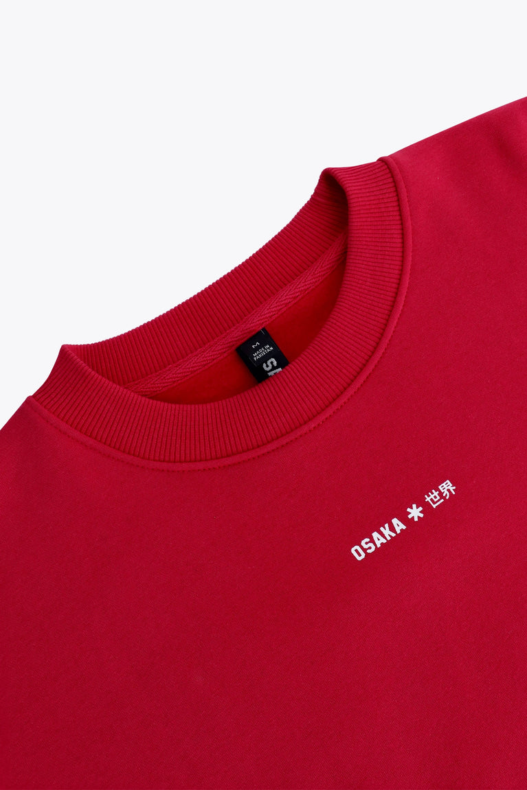 Osaka women sweater in red with logo in white. Front flatlay detail neck view